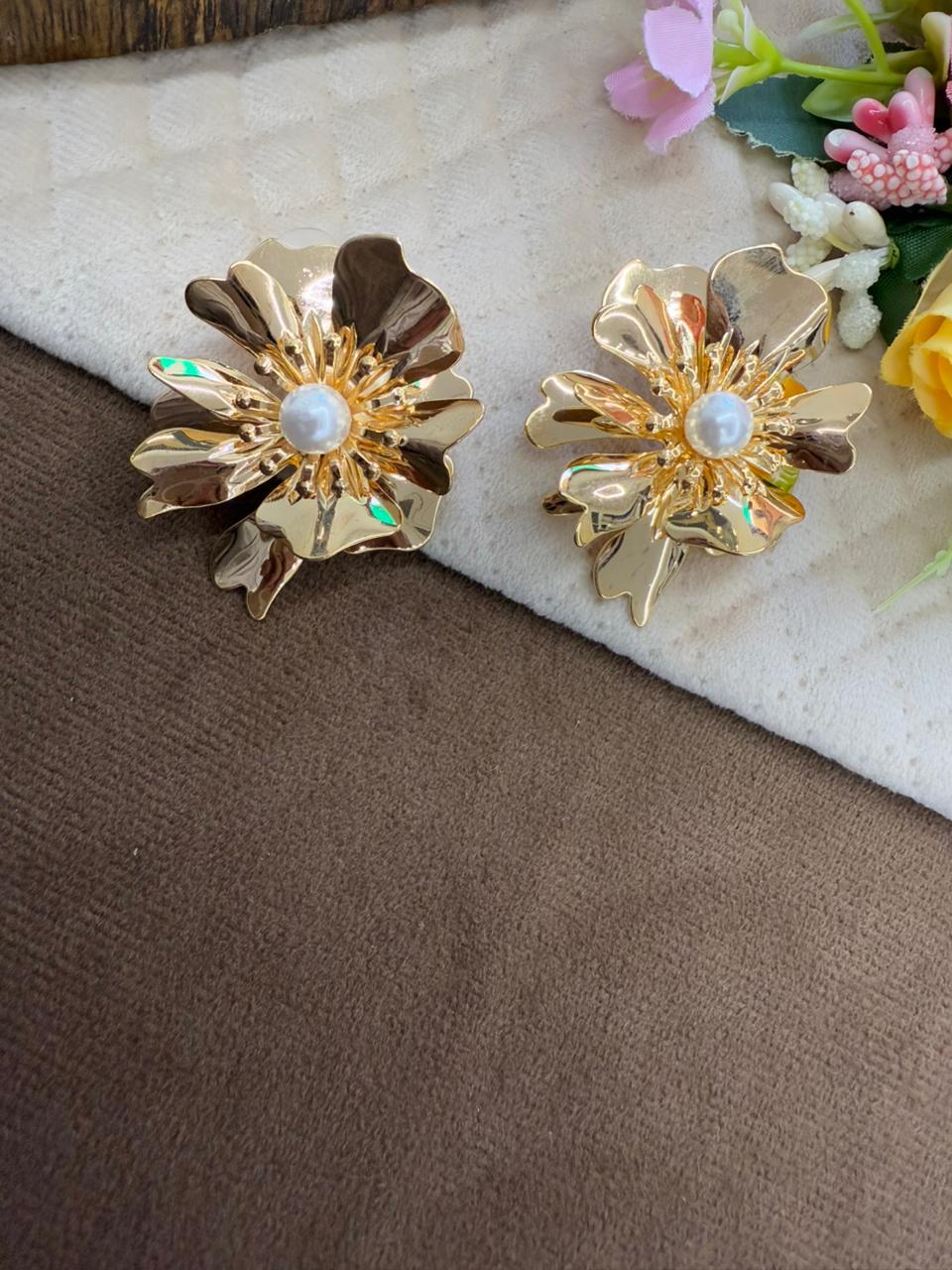 Brass floral studs in golden polish with pearl studded at the centre for girls and women